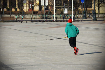 Young hockey player training on empty square