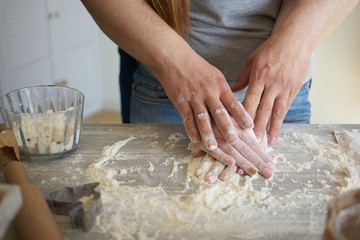 Obraz na płótnie Canvas women's and men's hands mix wheat flour. baker's hand closeup.couple together Cooking pizza, bread