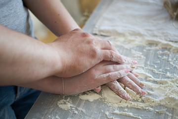 women's and men's hands mix wheat flour. baker's hand closeup.couple together Cooking pizza, bread