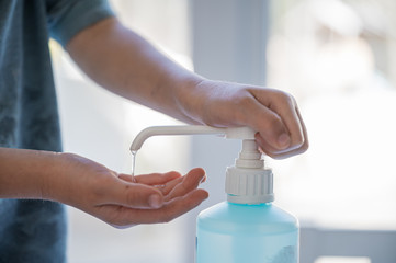 Closeup of a child using hand sanitizer disinfectant