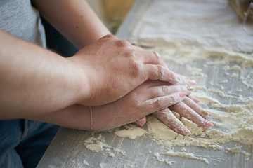 women's and men's hands mix wheat flour. baker's hand closeup.couple together Cooking pizza, bread