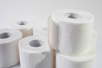 White toilet paper rolls on the gray background.