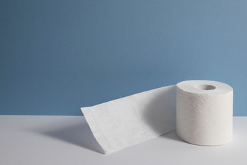 Roll of toilet paper on a blue background.