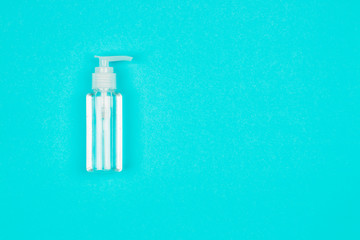 Hand alcohol sanitizer gel on blue background. Coronavirus protection. Top view. Flat lay.