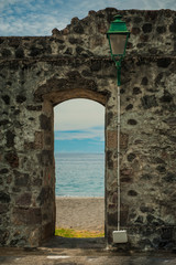 Obraz na płótnie Canvas Old Stone doorway and tropical beach