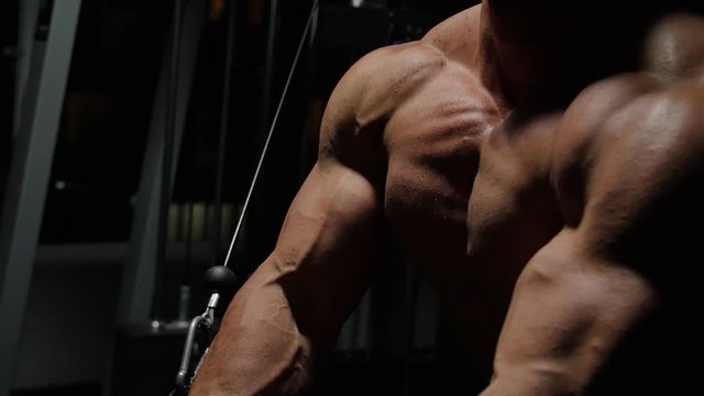  Bodybuilder shakes muscles in the gym. 