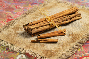 Ground cinnamon, cinnamon sticks, on old wooden background