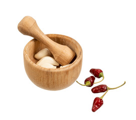 Handmade wooden mortar with pepper on a white background