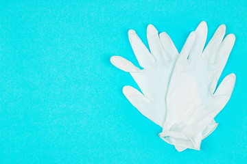 White latex gloves on blue background. Coronavirus protection. Top view. Flat lay.
