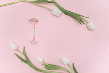 Beauty make up products on a pastel pink background with white tulips. Top view. beauty blog content, fresh blog background. 