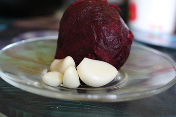 red beets and garlic cloves on a plate