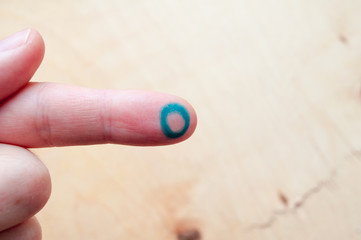 World Diabetes Day. Hand holds a blue circle. Symbol of diabetes. Insulin dependence