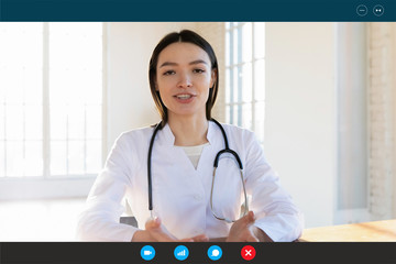 Headshot portrait screen application view of positive female doctor consult client online on Webcam...