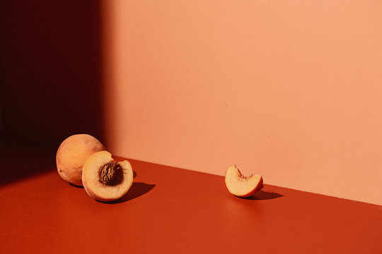 Peaches on Coral Colored Background