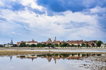 View on Warsaw City Center and Old Town from Vistula river with reflection in water at day. Poland, Europe