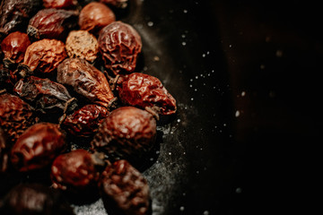 black table top with rose hips,