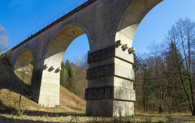 Ancient railway bridge against the blue sky