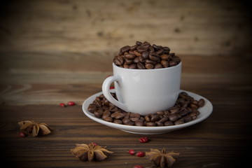 cup of coffee and beans on wooden background
