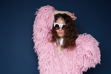 Attractive lady moves body actively, raises hands, has fun during party, feels rhythm of music,...