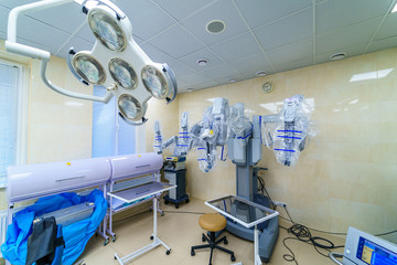 Fototapeta na wymiar Surgical room in hospital with robotic technology equipment, machine arm surgeon in futuristic operation room. Minimal invasive surgical innovation, medical robot surgery with endoscopy