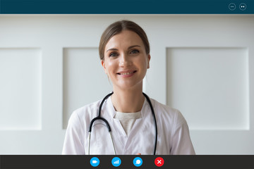 Headshot portrait screen application view of smiling female nurse talking on video call with sick...