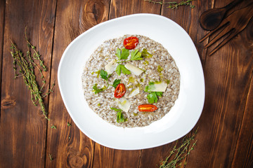 Risotto with truffle sauce, olive oil and tomatoes, Italian cuisine, top view, horizontal