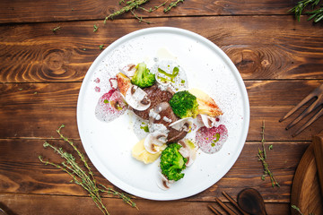 Pieces of beef meat, steaks with different sauces and decorative elements, restaurant kitchen, top view, horizontal