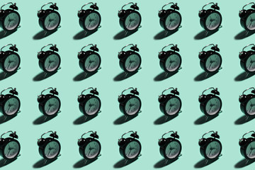 Pattern of black alarm clock on background of aqua menthe color.