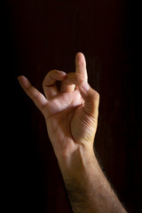 Man hand on black background. Gesture language with the hands. Non-verbal communication concept.