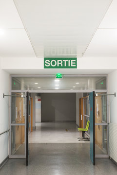 View of hospiral corridor with Exit panel writing in french : Sortie, traduction in english of exit
