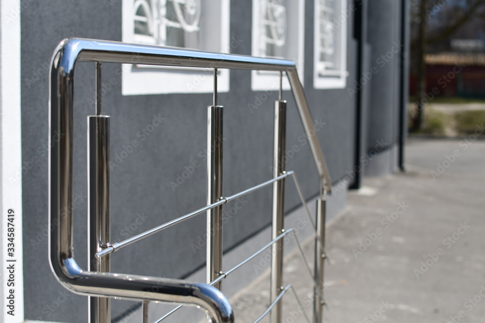 Wall mural Stainless steel handrails, stairs and grey wall.