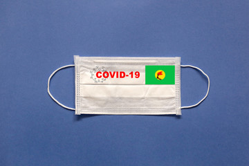Flag of Zaire and inscription COVID-19 on a medical mask on a blue background. Healthcare and medical concept. Pandemic virus COVID-19