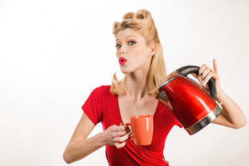 Pretty girl preparing tea or coffee. Pinup woman with cup of hot tea.