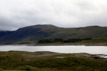 Obraz premium Skye Island (Scotland), UK - August 15, 2018: Typical landscape of Scotland, Isle of Skye, Inner Hebrides, Scotland, United Kingdom