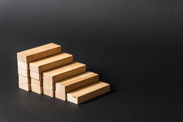 Reduction graph of wooden blocks. Financial concept. Copy the space. on a dark background 