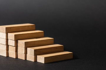 Reduction graph of wooden blocks. Financial concept. Copy the space. on a dark background 