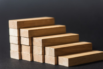 Reduction graph of wooden blocks. Financial concept. Copy the space. on a dark background 