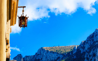 Street lamp and mountains and blue sky in Capri reflex