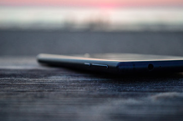 Phone on wooden desk in focus