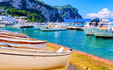Fototapeta na wymiar Marina with boats in Capri Island town at Naples Italy reflex