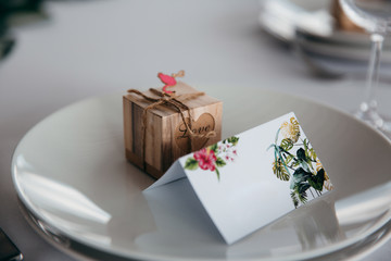 Wooden wedding invitation card on plate