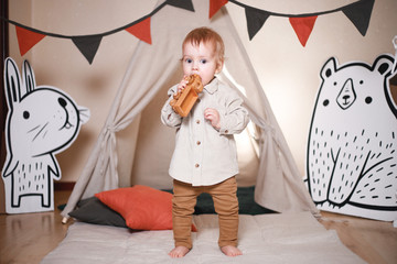 Cute little boy playing in a teepee