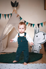 Cute little boy playing in a teepee