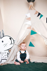 Cute little boy playing in a teepee