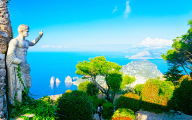Statue and green gardens at Capri Island town reflex