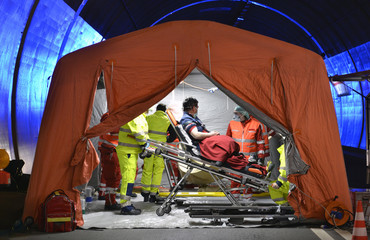 Alert Covid-19. Man on stretcher is visited inside a temporary hospital field tent for the first...