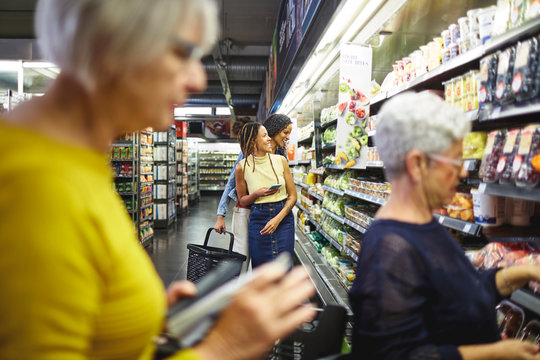 Women grocery shopping in supermarket