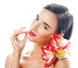 Fototapeta premium young pretty brunette woman with red flower amaryllis close up isolated on white background. Fancy fashion makeup, bright lipstick, creative Ombre manicured nails. spa skin care