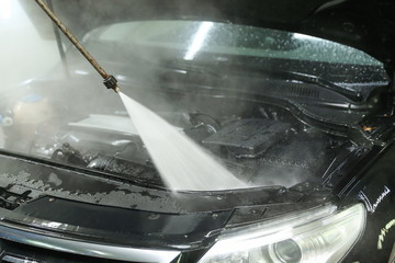 car engine washing close-up. water jet washes a car engine