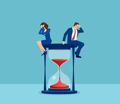 Vector of a stressed business man and business woman sitting on a hourglass